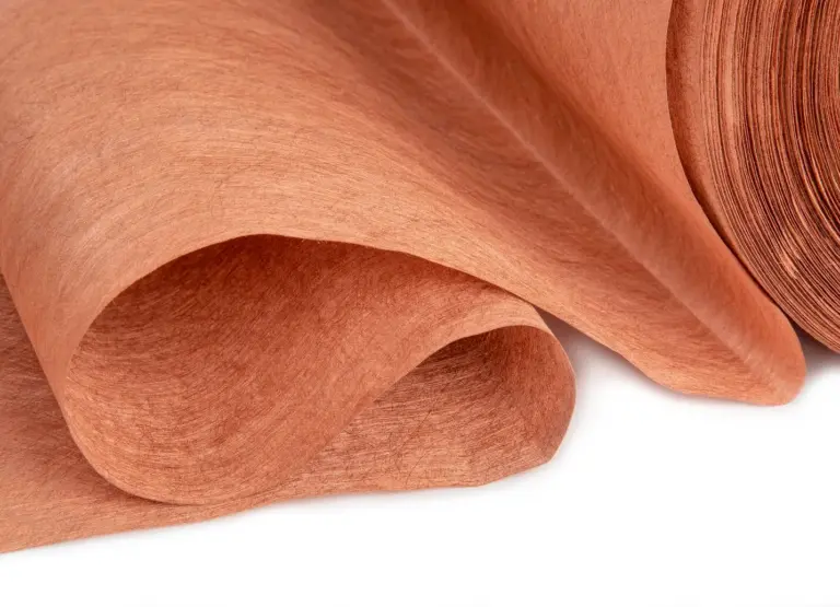Close-up of copper-colored shielding nonwoven fabric – innovative material for effective protection against electrosmog and 5G radiation.