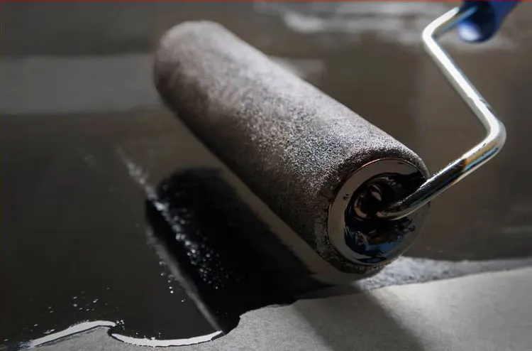 Close-up of a paint roller applying conductive shielding paint – effective protection against electrosmog and 5G radiation indoors.